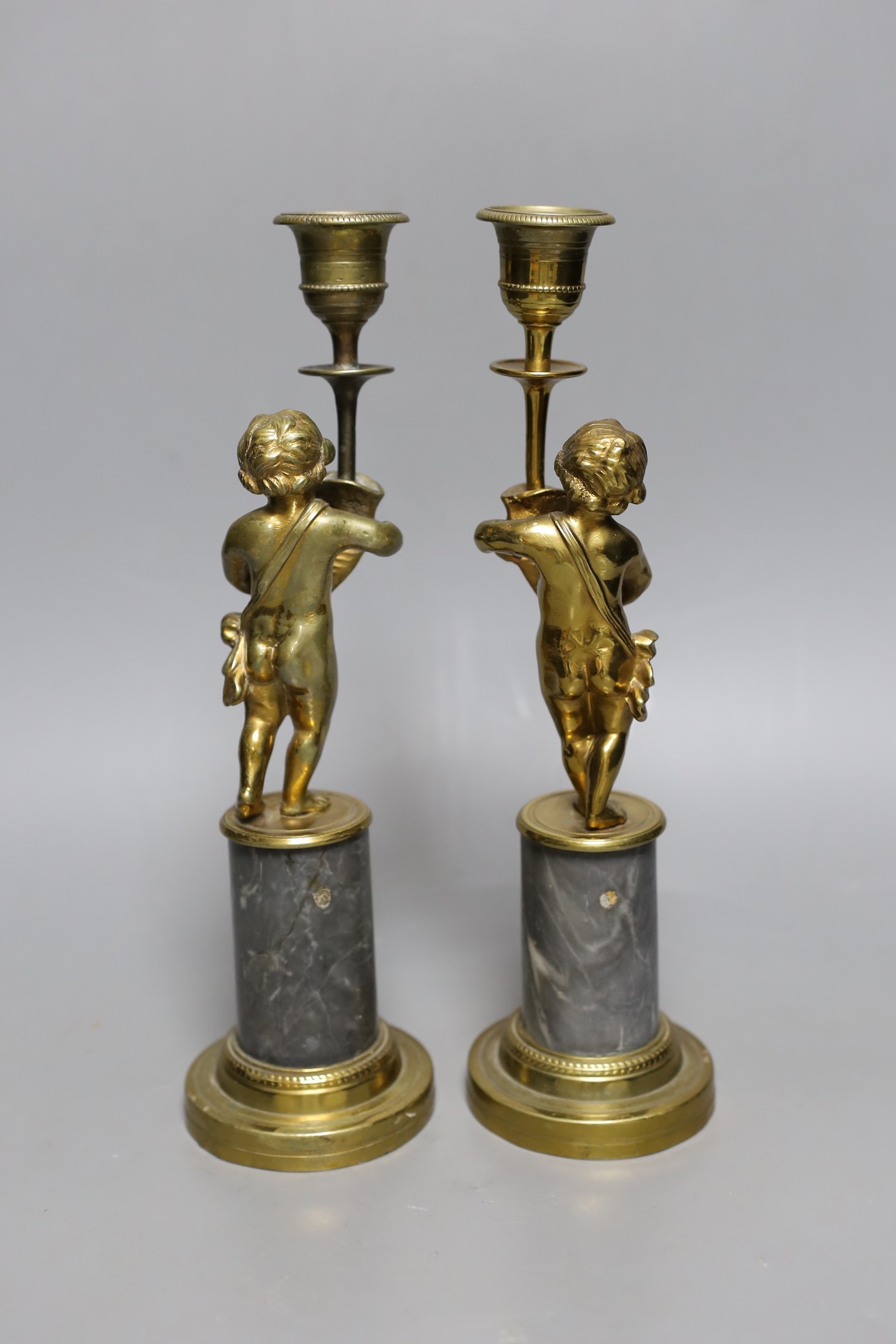 A pair of early 20th century gilt brass figural candlesticks, 27.5cm